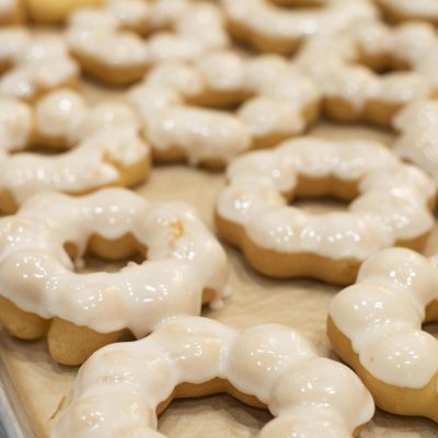 Freshly baked mochi donuts with glaze, captured in a bakery in San Francisco.