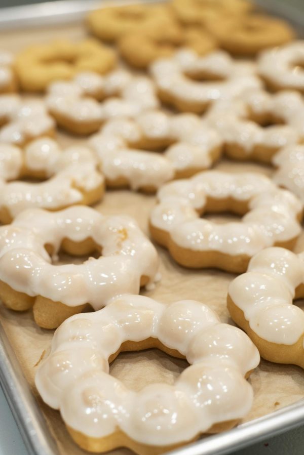 Freshly baked mochi donuts with glaze, captured in a bakery in San Francisco.